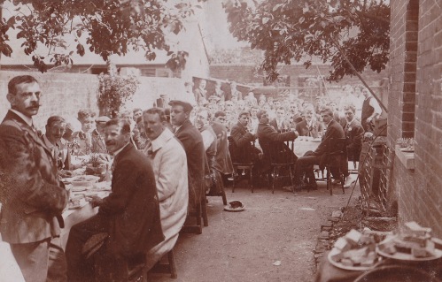Coronation Party 1911 sepia image eating food